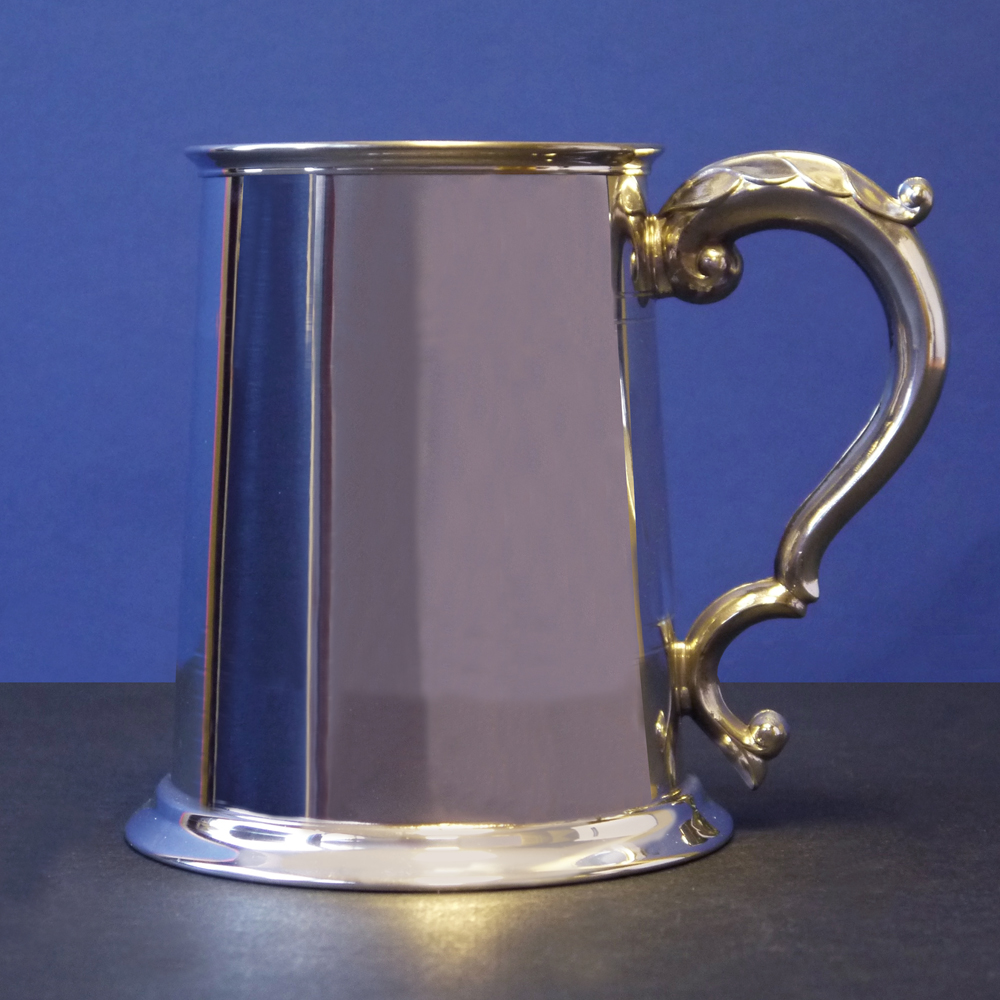 Pewter tankard jug with detailed handle